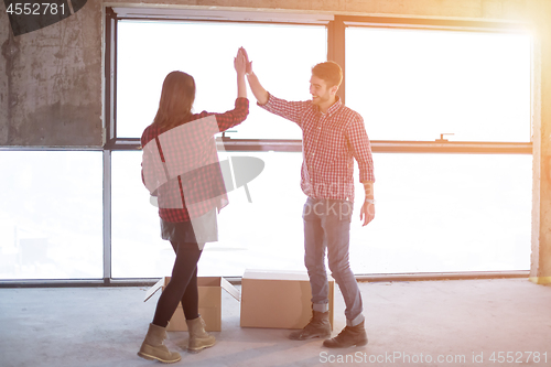 Image of business team carrying cardboard boxes