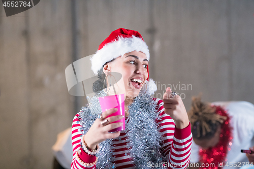 Image of young multiethnic business couple celebrating new year party