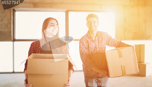 Image of business team carrying cardboard boxes