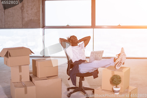 Image of young black casual businessman taking a break on construction si