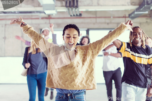 Image of young multiethnic business people dancing in unfinished startup 