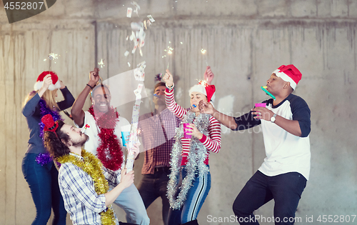 Image of multiethnic group of casual business people having confetti part