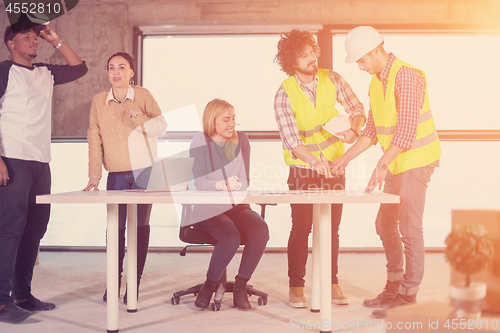 Image of group of multiethnic business people on construction site