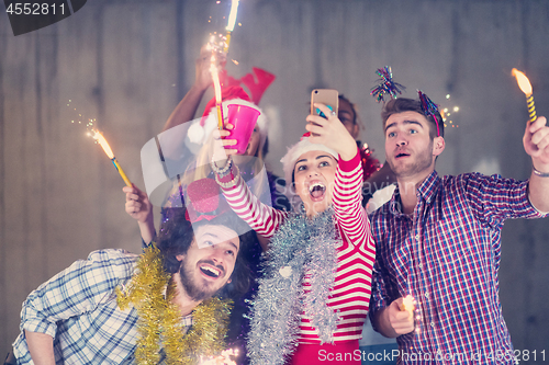 Image of multiethnic group of casual business people taking selfie during