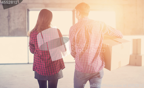 Image of business team carrying cardboard boxes