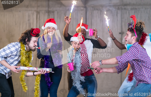 Image of multiethnic group of casual business people dancing with sparkle