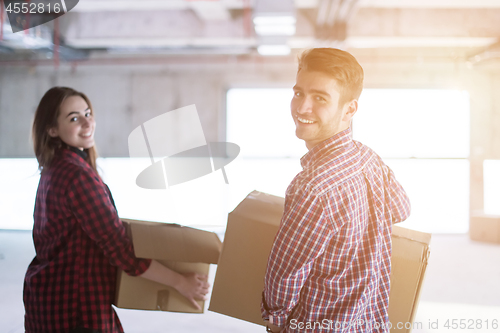 Image of business team carrying cardboard boxes