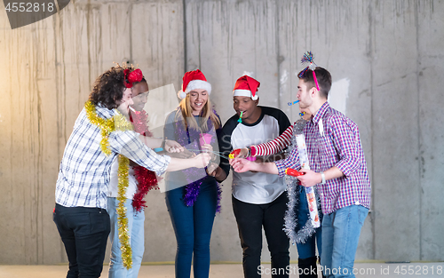 Image of multiethnic group of casual business people lighting a sparkler