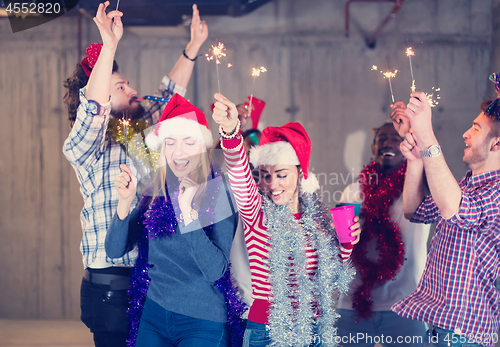 Image of multiethnic group of casual business people dancing with sparkle