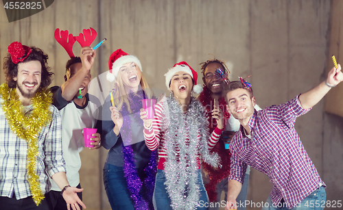 Image of multiethnic group of casual business people dancing with sparkle