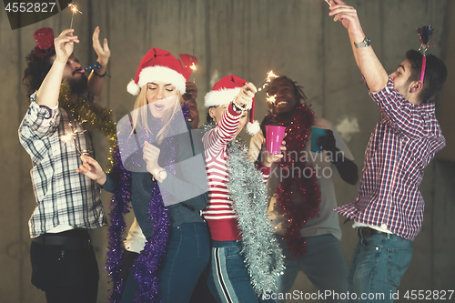 Image of multiethnic group of casual business people dancing with sparkle