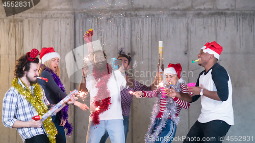 Image of multiethnic group of casual business people having confetti part