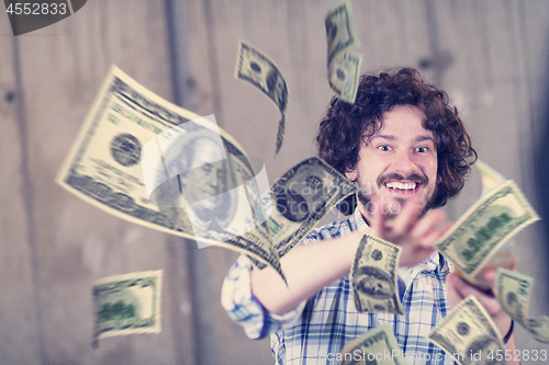 Image of businessman making the rain of money