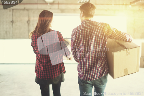 Image of business team carrying cardboard boxes