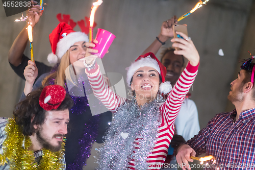 Image of multiethnic group of casual business people taking selfie during