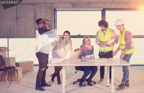 Image of group of multiethnic business people on construction site