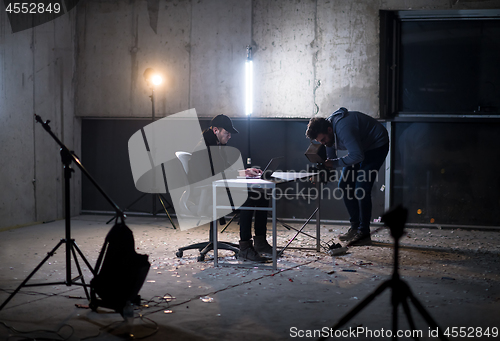 Image of videographer recording talented hacker while working in dark off