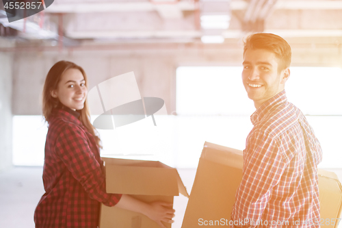 Image of business team carrying cardboard boxes