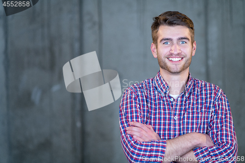 Image of portrait of casual businessman in front of a concrete wall