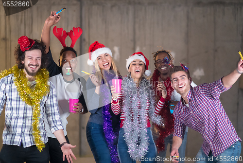 Image of multiethnic group of casual business people dancing with sparkle