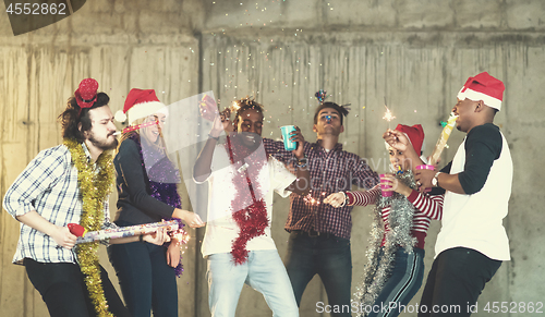 Image of multiethnic group of casual business people having confetti part