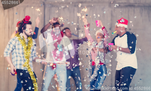 Image of multiethnic group of casual business people having confetti part