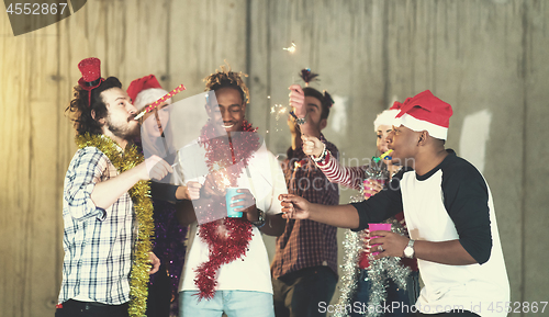 Image of multiethnic group of casual business people lighting a sparkler