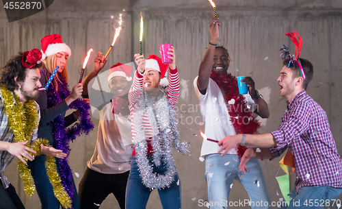 Image of multiethnic group of casual business people having confetti part