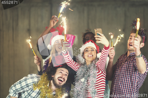 Image of multiethnic group of casual business people taking selfie during