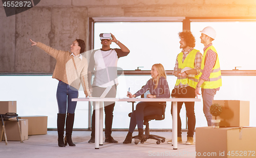 Image of group of multiethnic business people on construction site