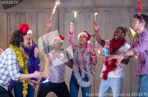 Image of multiethnic group of casual business people dancing with sparkle