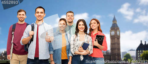 Image of group of students showing thumbs up over london