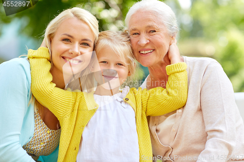 Image of woman with daughter and senior mother at park