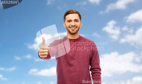 Image of happy young man showing thumbs up