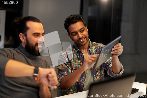 Image of creative team with tablet pc working at office