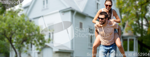 Image of couple having fun in summer over house background