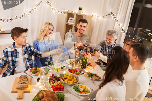 Image of happy family having dinner party at home