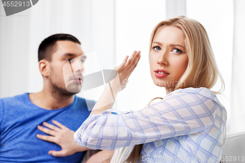 Image of unhappy couple having argument at home