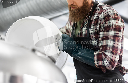 Image of brewer working at craft brewery or beer plant