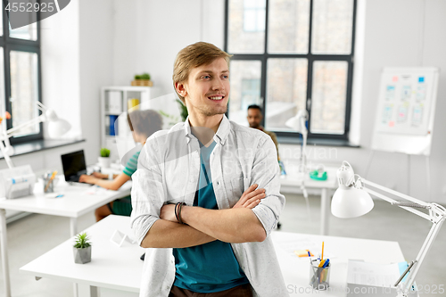 Image of man with crossed hands at office