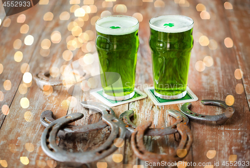 Image of glasses of green beer with shamrock