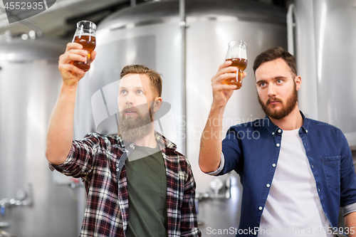 Image of men drinking and testing craft beer at brewery