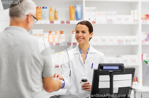 Image of apothecary selling drug to senior man at pharmacy