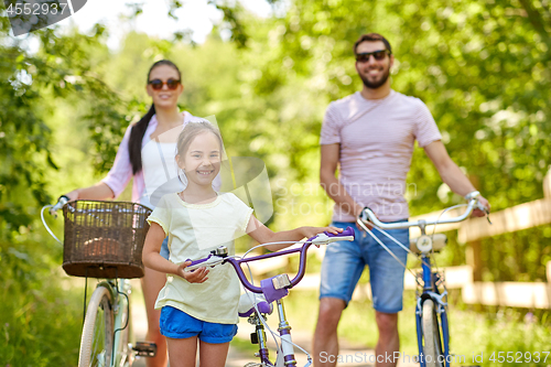 Image of happy family with bicycles in summer park