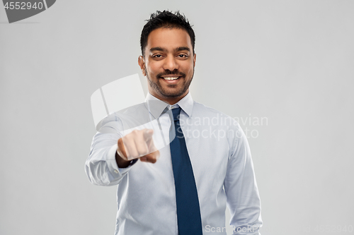Image of indian businessman in shirt with tie over grey