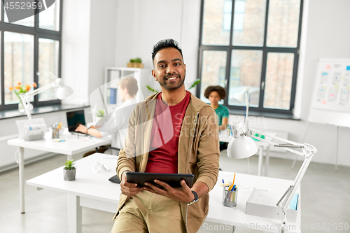 Image of indian man with tablet pc computer at office