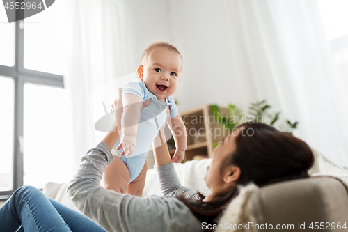 Image of happy mother with little baby son at home