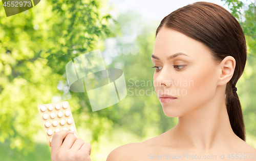 Image of young woman with pills