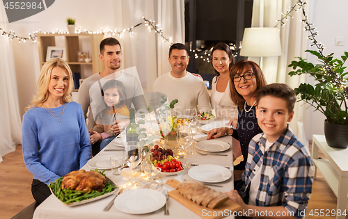 Image of happy family having dinner party at home