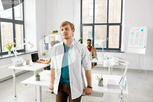 Image of man standing at office table